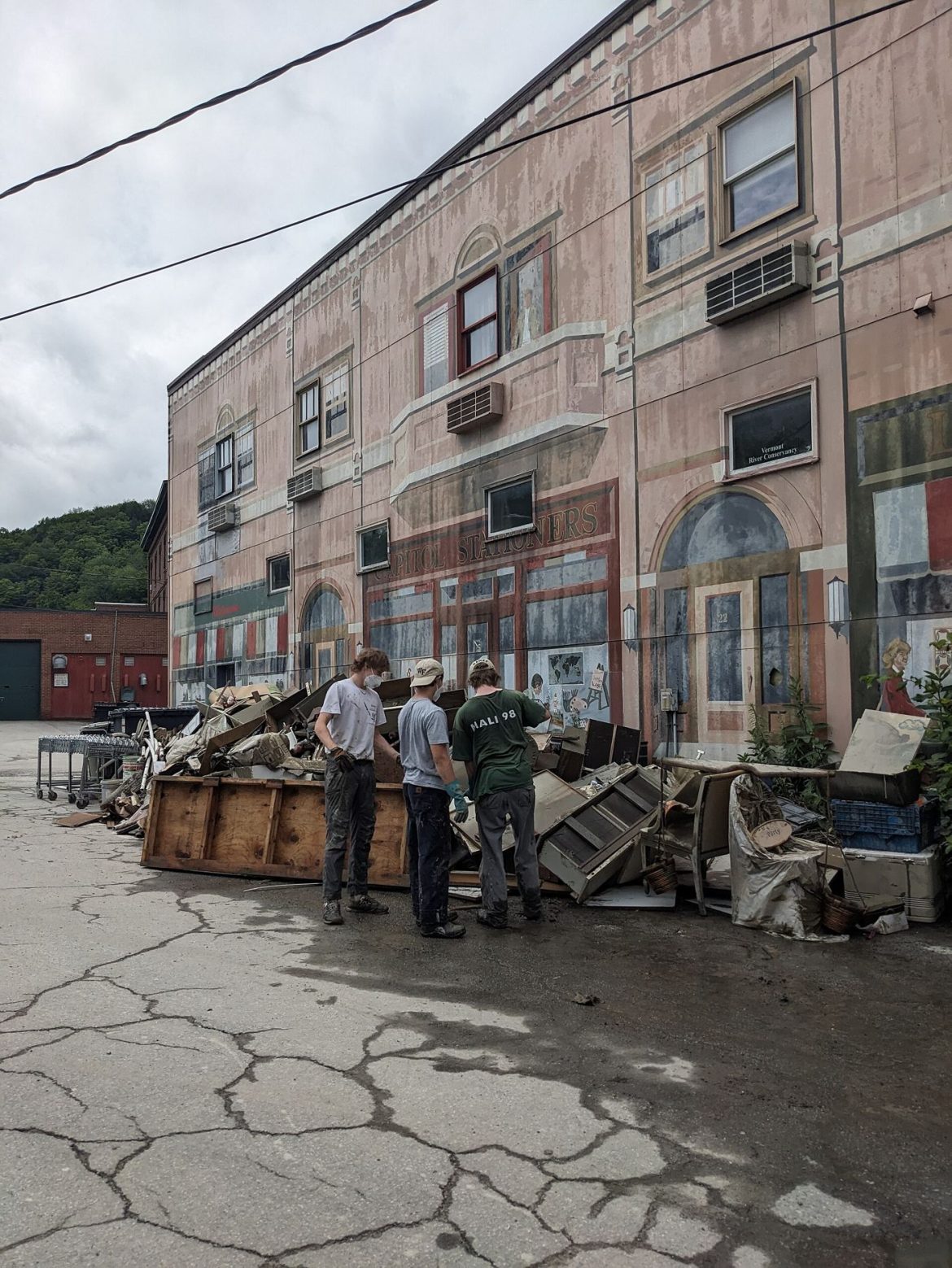 workers cleaning up a flooded street