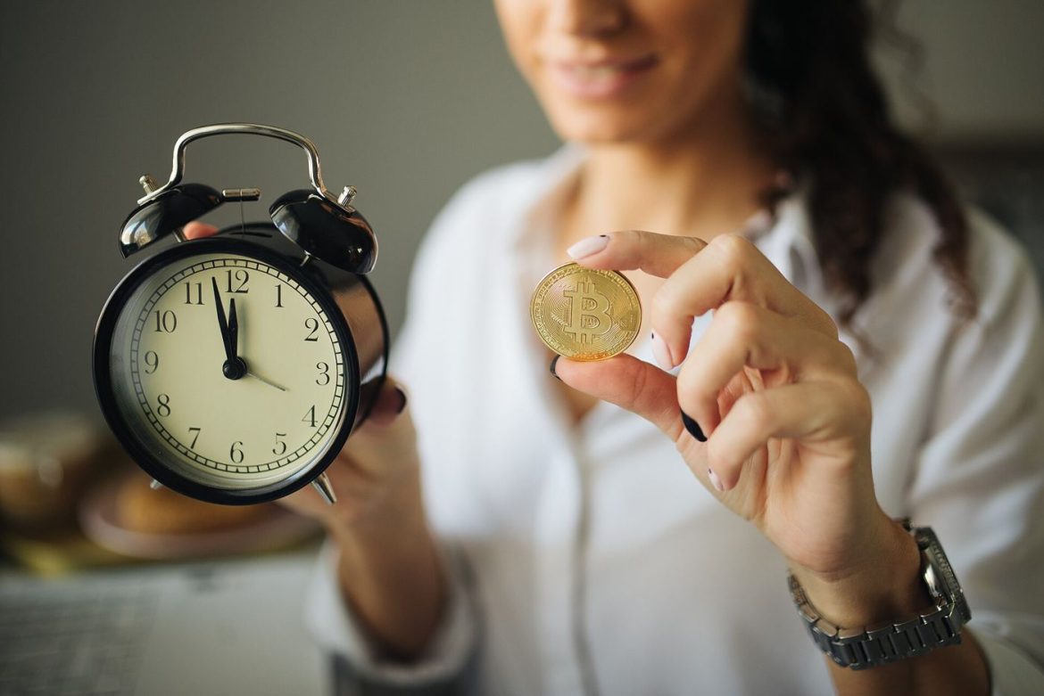 bitcoin coin in front of trading charts
